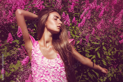 Sexy woman in pink dress with pink flowers © Artem Popov