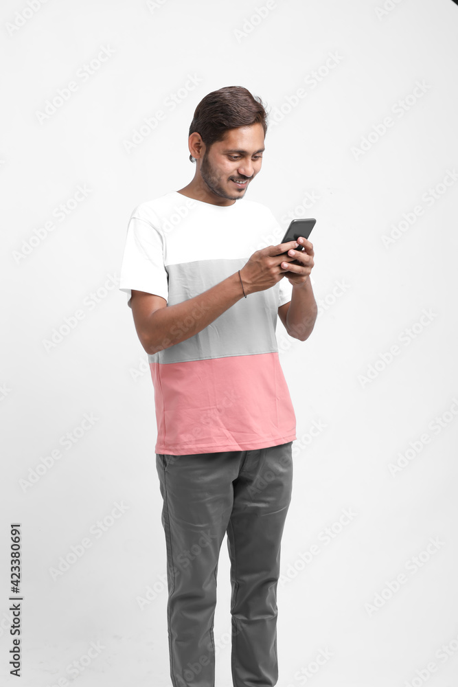 Young indian / Asian man using mobile Young indian / Asian man using mobile