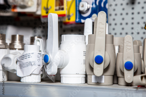 in a hardware store on a windscreen are polypropylene ball valves for hot and cold water with lever handles. photo