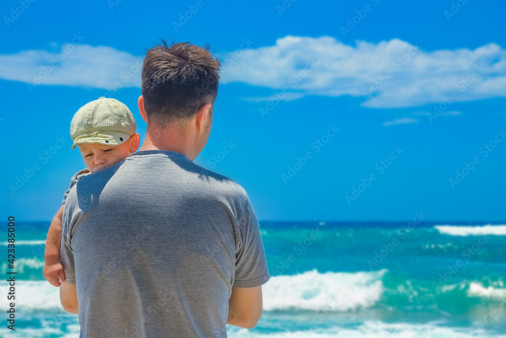 Fototapeta premium happy parent with a child by the sea in the open air