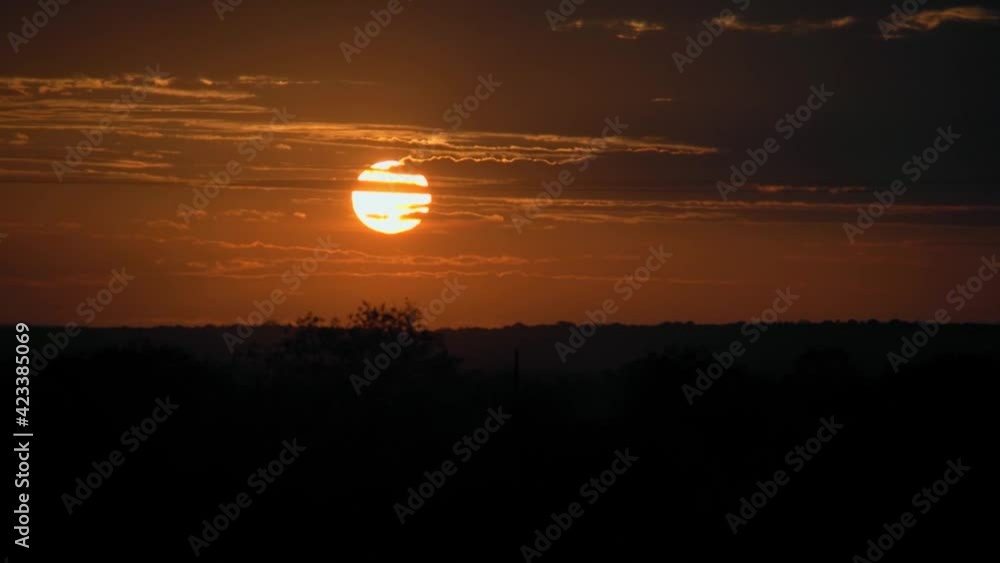 sunset inland in fast motion with silhouette of landscape at the bottom sunset inland in fast motion with silhouette of landscape at the bottom