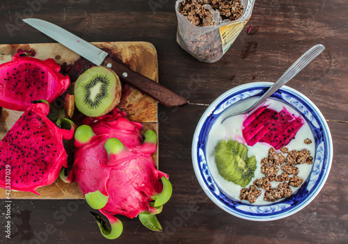 Breakfast bowl with yoghurt cereal and dragon fruit. Healthy yoghurt and fruit bowl. Fit breakfast. Exotic and tropical fruit. Kiwi. Dragon fruit. Pitaya