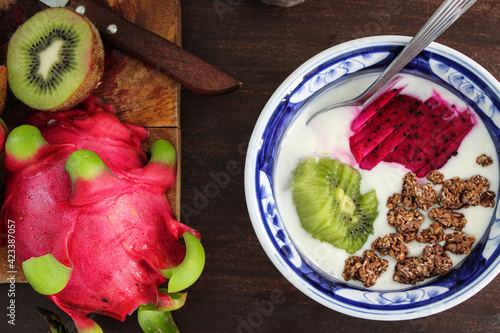 Breakfast bowl with yoghurt cereal and dragon fruit. Healthy yoghurt and fruit bowl. Fit breakfast. Exotic and tropical fruit. Kiwi. Dragon fruit. Pitaya