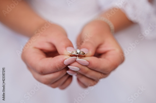 Gold ring with a stone in the hands of the bride