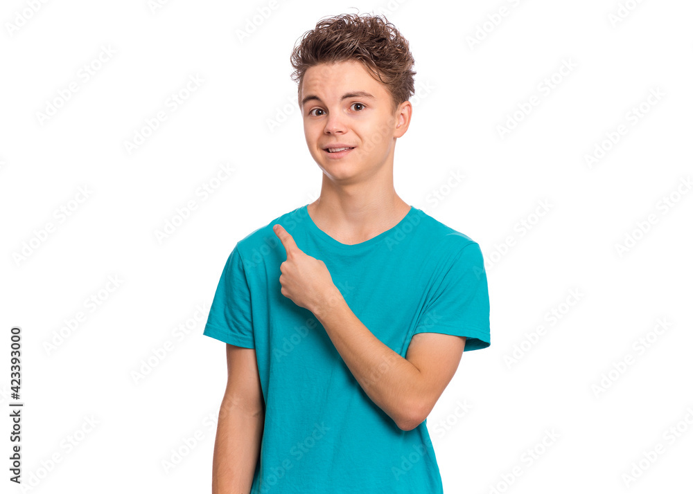 Cute teen boy pointing up, gesturing idea or doing number one gesture, isolated on white background Cute teen boy pointing up, gesturing idea or doing number one gesture, isolated on white background