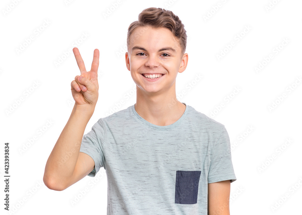 Happy boy showing victory sign isolated on white background Happy boy showing victory sign isolated on white background