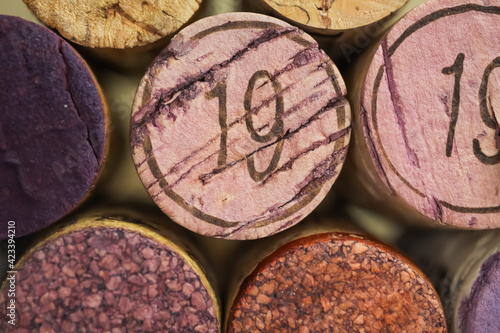 Makro closeup of pile isolated vintage red wine corks with number 19  focus on center 