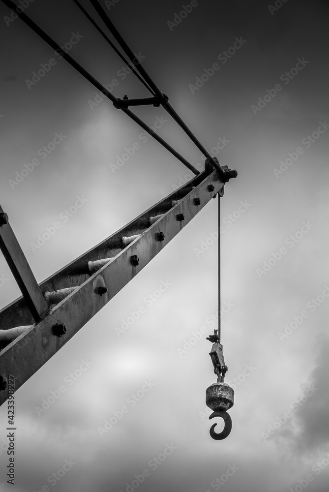 Lifting crane against a cloudy sky in black and white Lifting crane against a cloudy sky in black and white