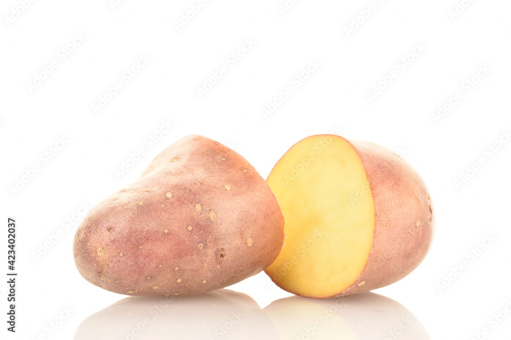 Two halves of unpeeled raw potatoes, close-up, isolated on white. Two halves of unpeeled raw potatoes, close-up, isolated on white.