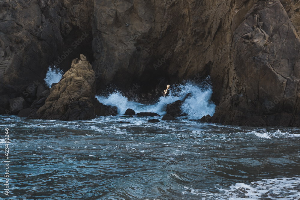 Waves crashing through rocks in Big Sur, California Waves crashing through rocks in Big Sur, California
