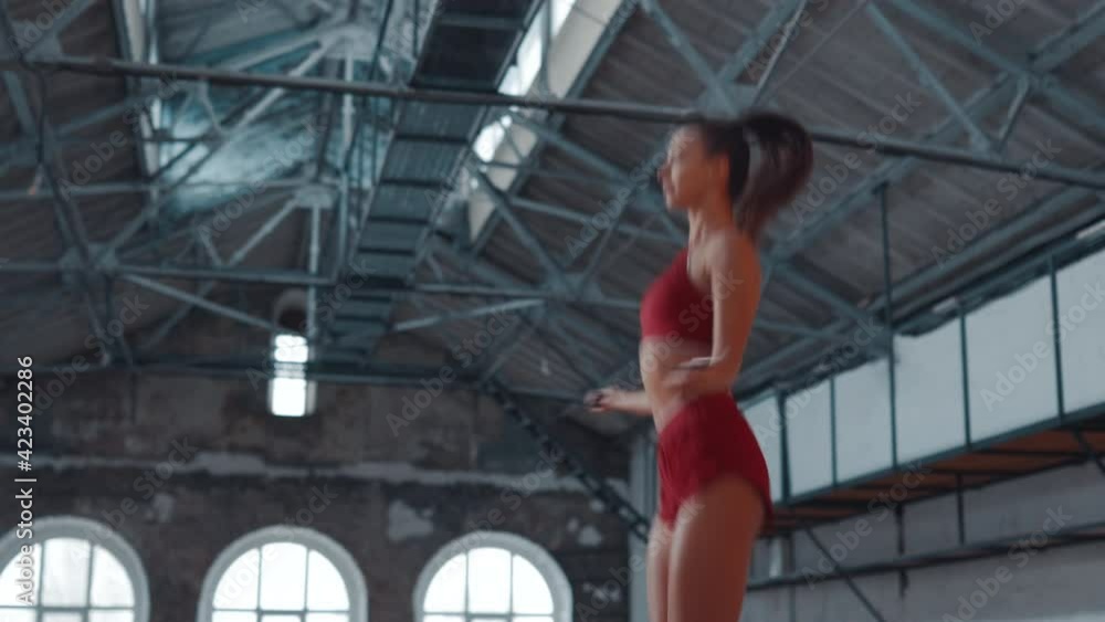 Beautiful woman in sportswear is jumping rope in the gym. Healthy lifestyle. Sports activities. Beautiful woman in sportswear is jumping rope in the gym. Healthy lifestyle. Sports activities.