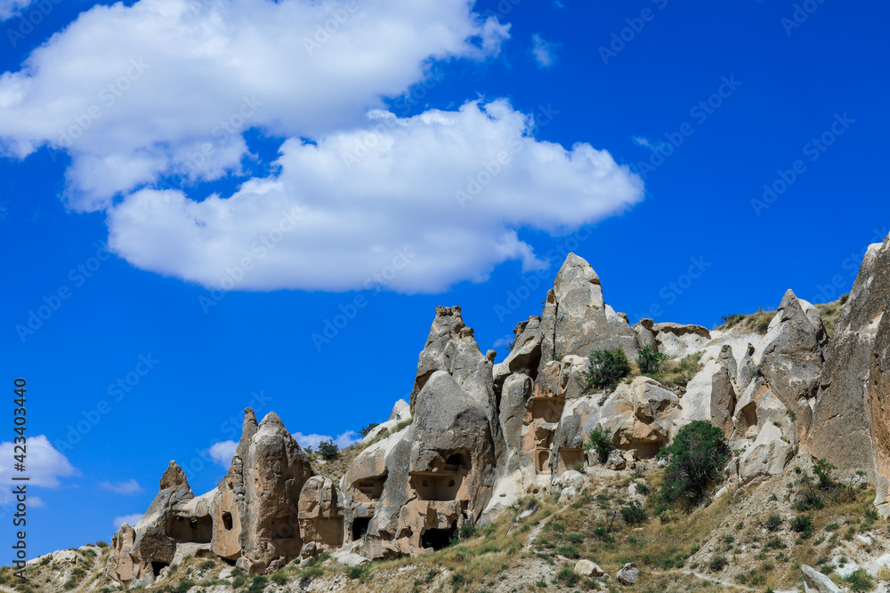 Fantastic View to the Göreme with rock houses in front of the spectacularly coloured valleys nearby, Cappadocia, Turkey