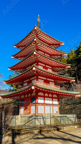 A close up view on iconic Chureito pagoda on a hilltop facing Mt. Fuji in Arakurayama Sengen Park, Japan. It can be reached via 398 steps. The pagoda has five stories and distinctive red color.