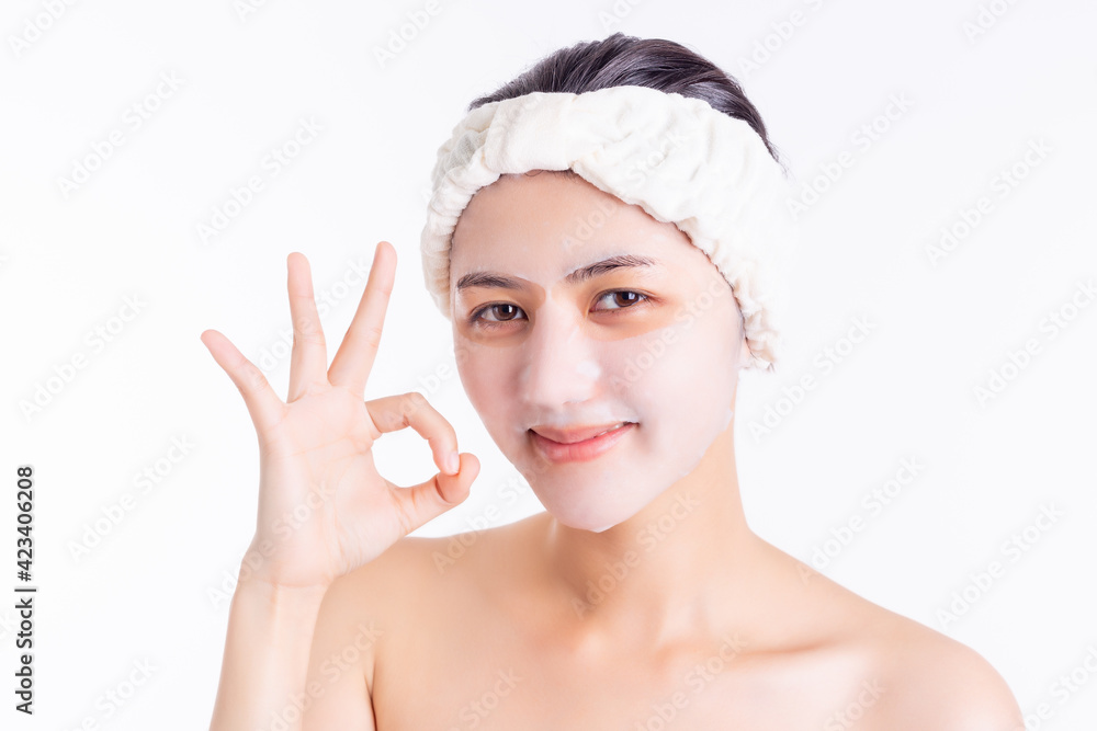 Young woman applying facial sheet mask on beauty face Attractive beautiful girl use facial mask for anti aging on beauty face. cosmetology, facial care concept copy space, isolated on white Young woman applying facial sheet mask on beauty face Attractive beautiful girl use facial mask for anti aging on beauty face. cosmetology, facial care concept copy space, isolated on white