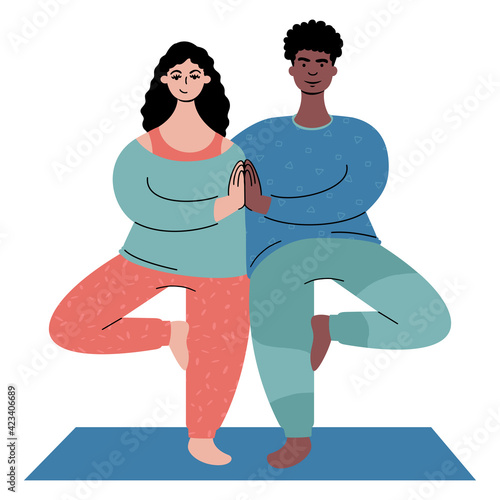 couple practicing yoga together. A man and a woman standing in a tree pose.