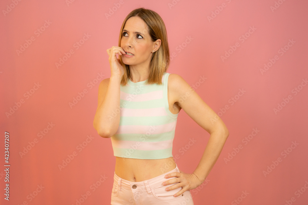 Portrait of a pensive casual woman looking away at copy space isolated over pink background Portrait of a pensive casual woman looking away at copy space isolated over pink background