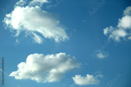 Beautiful celestial landscape with group of white cumulus clouds high in the stratosphere on a sunny summer day