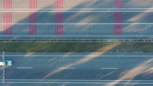 Truck passing on a noise section of road with relief noise strips markings on the asphalt - asphalt rumble strips on motorway surface - aerial top view shot