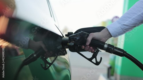 Filling car with gas fuel at station pump. Car filling up with fuel. Diesel Oil. Gas nozzle in car's fuel tank. Fuel, gas station, petrol prices concept. photo