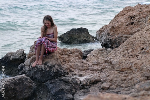 woman on the beach reads a book  © Viktoriya