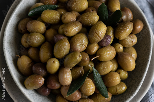 Marinated olives with herbs and spices, healthy natural food ingredients