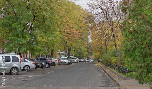 Pushkinskaya Street in autumn day. On the street there are cars © aleks