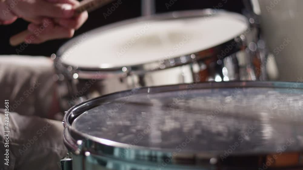 Drummer playing groove on timpani drum, floor tom at concert Drummer playing groove on timpani drum, floor tom at concert