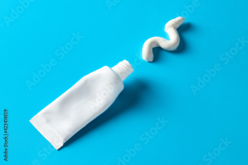 The toothpaste tube on blue background , essential thing for oral hygiene concept.