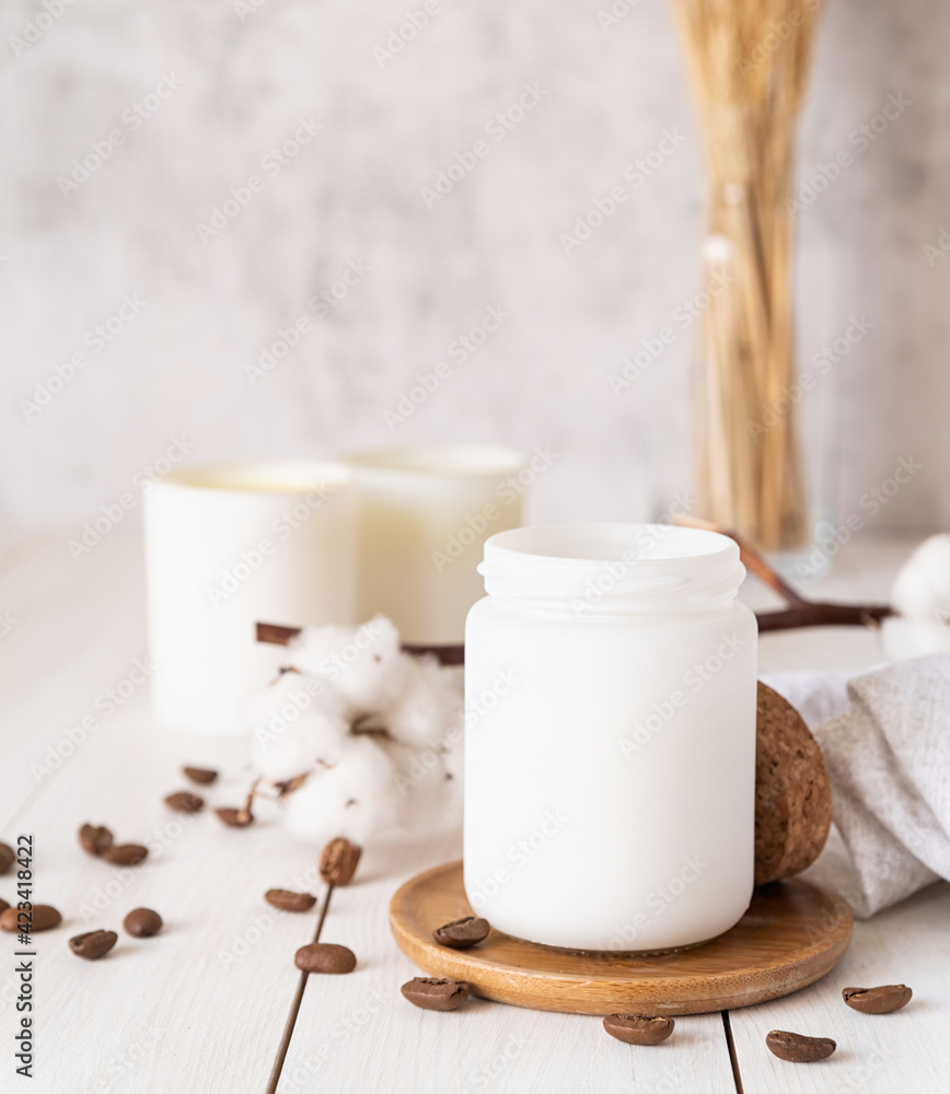 Beautiful burning candles with cotton flowers and coffee beans on white wooden background Beautiful burning candles with cotton flowers and coffee beans on white wooden background