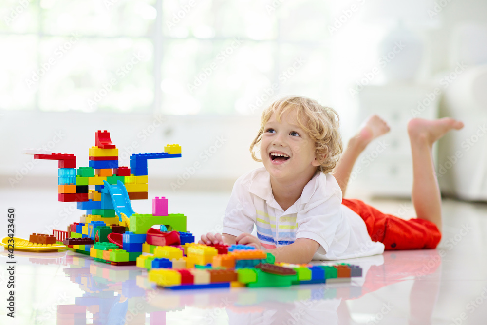 Child playing with toy blocks. Kids play. Child playing with toy blocks. Kids play.