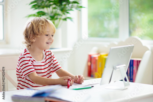 Online remote learning. School kids with computer.