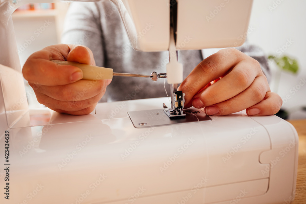 Professional seamstress can fix her modern sewing machine StockFoto