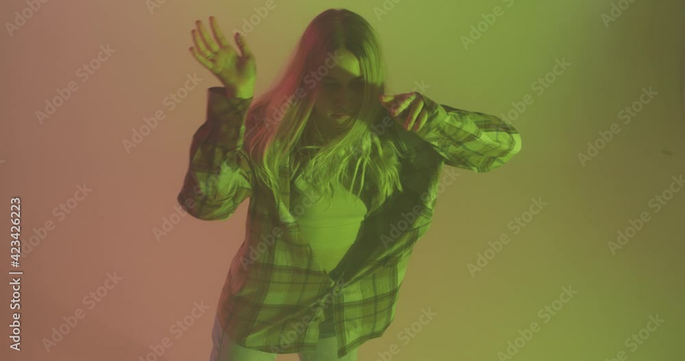4k video of stylish young teen girl, cool dancing modern funky free style dance in yellow neon light 4k video of stylish young teen girl, cool dancing modern funky free style dance in yellow neon light