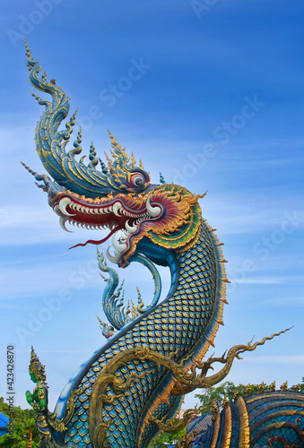 Dragon guard - exterior detail of Famous Wat Rong Suea Ten  or Blue Temple in Chiang Rai  Northern Thailand
