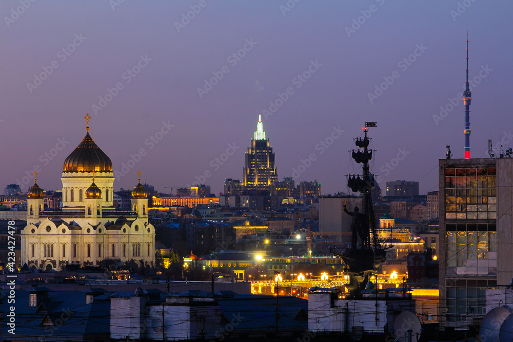 Panorama of Moscow with the Cathedral of Christ the Savior, the monument to Peter I, the Ostankino tower with the purple sky background.