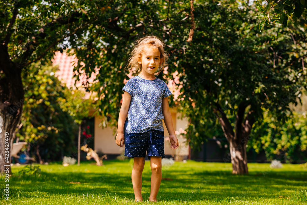 Active little girl has fun on the backyard Active little girl has fun on the backyard