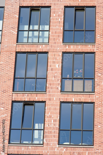 Closeup of a facade of brown bricks with window of a modern apartment