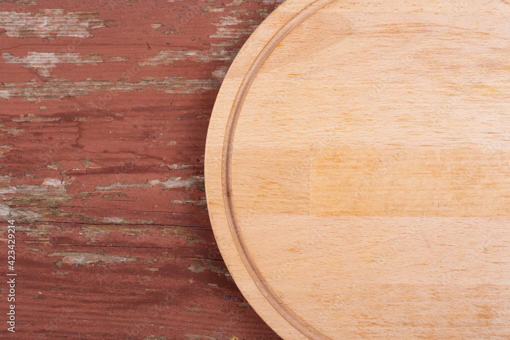 Fototapeta premium Cutting board for cutting bread, pizza or steak on a wooden background.
