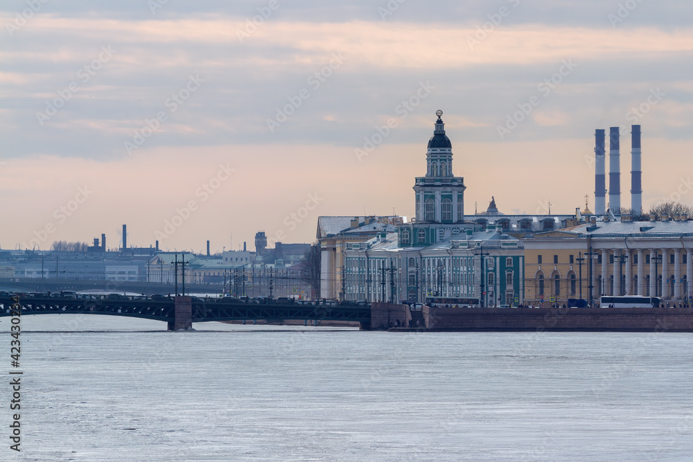 Saint-Petersburg, Russia - March 27, 2021: The Kunstkamera (or Kunstkammer) is the first museum in Russia. Architect Georg Johann Mattarnovy. Neva river. Palace Bridge.