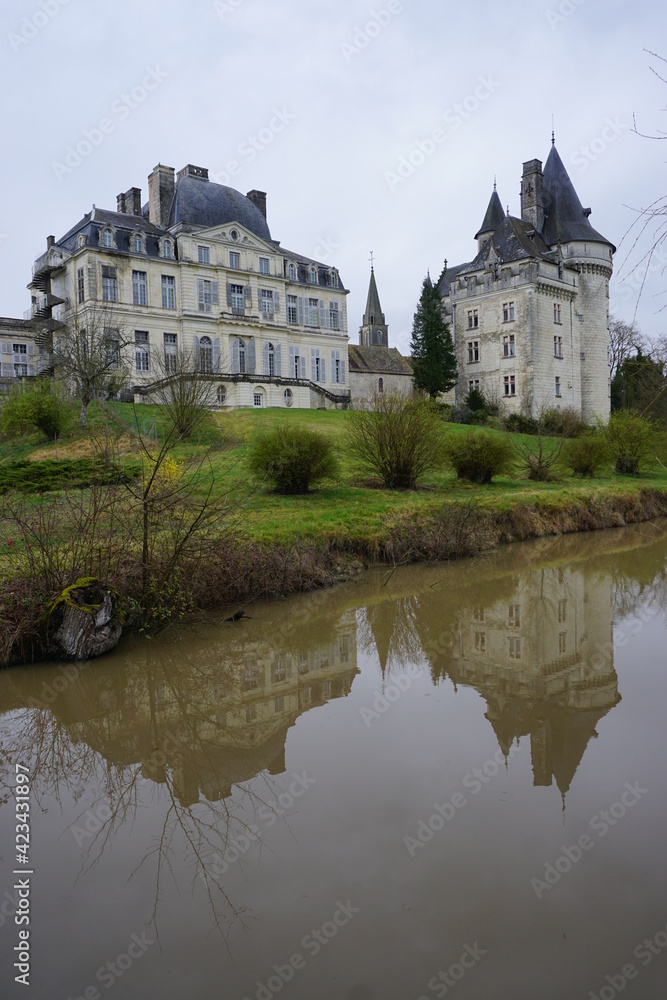 mirror reflection of the old stone castle on the river of Verneuil sur Indre, France