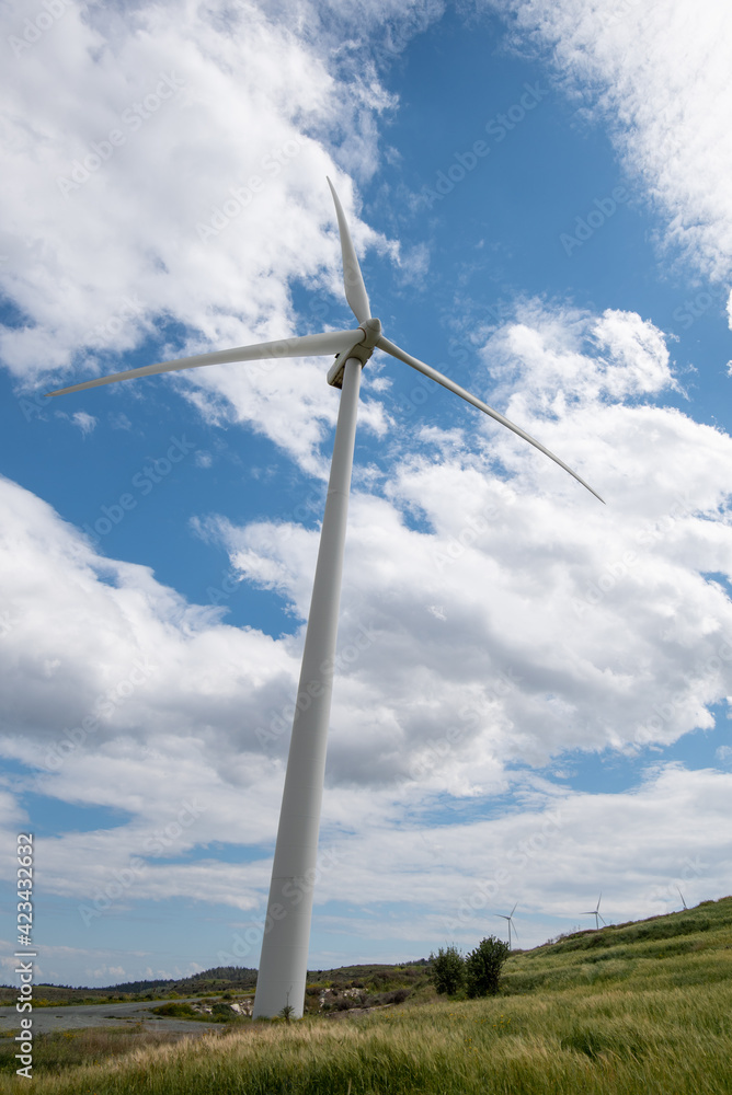 Windmills power generators on a turbine farm generating electricity from wind. Alternative renewable energy. Windmills power generators on a turbine farm generating electricity from wind. Alternative renewable energy.