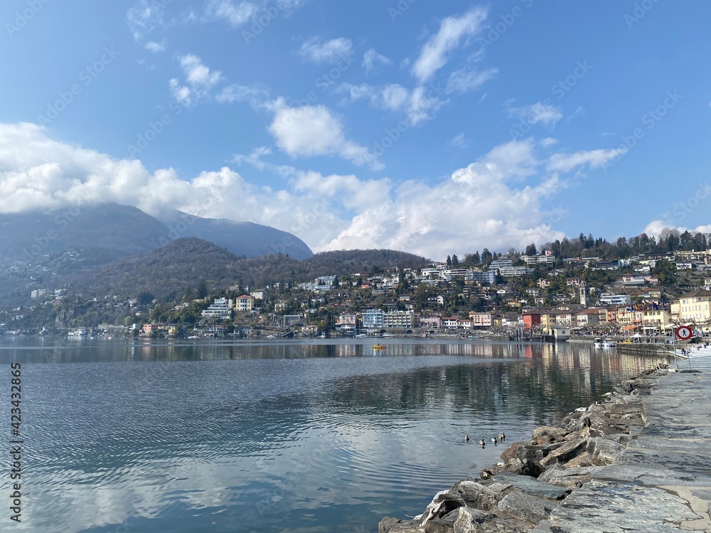 Fototapeta premium View of the city of Ascona, Switzerland. View of the lake and mountains, sunny day. Beautiful landscape