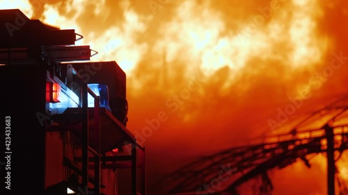 fire truck and flasher fire engine. fire on the roof of the house. a burning at building house night. home apartment insurance concept. huge fire blazes houses 911. property damage arson protection