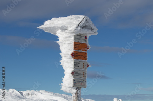 Tourist sign affected by cold wind