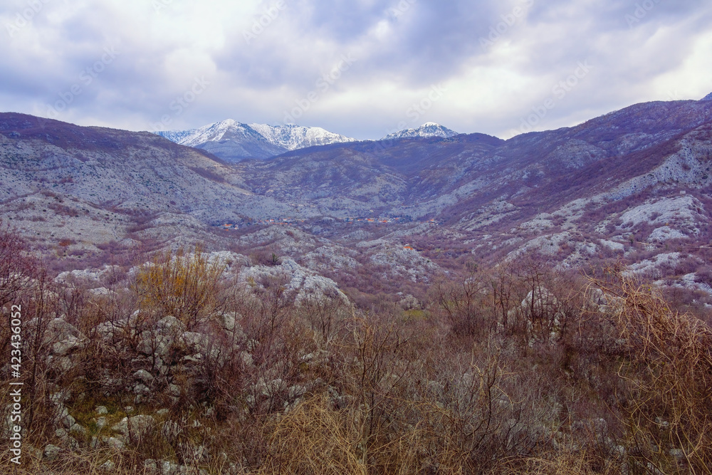 Fototapeta premium Beautiful mountain landscape on cloudy day in early spring. View of Orjen, Dinaric Mediterranean limestone mountain range. Montenegro
