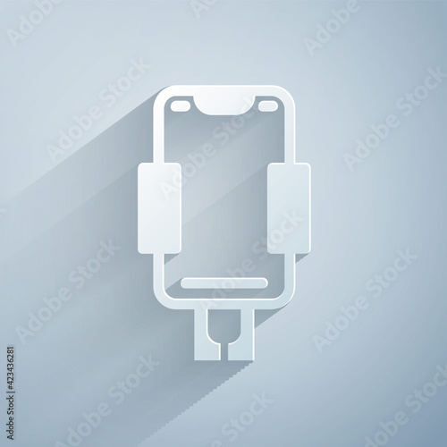 Paper cut Mobile phone holder icon isolated on grey background. Paper art style. Vector