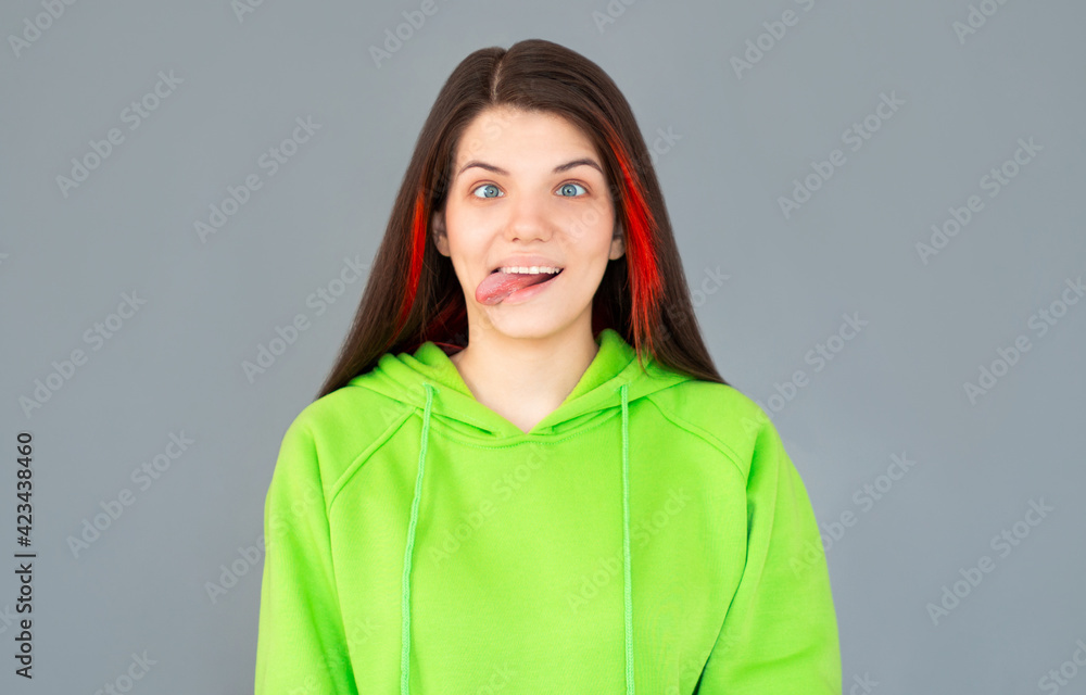 I lost my mind. The squint eyed woman with weird expression. Beautiful female half-length portrait isolated on gray studio backgroud. The crazy woman. The human emotions, april fools day