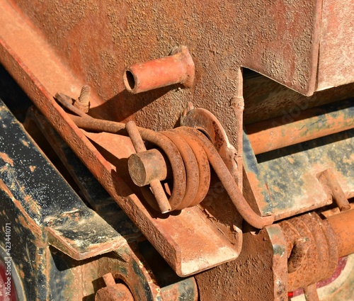 rusty metal spring coil pin on equipment trailer