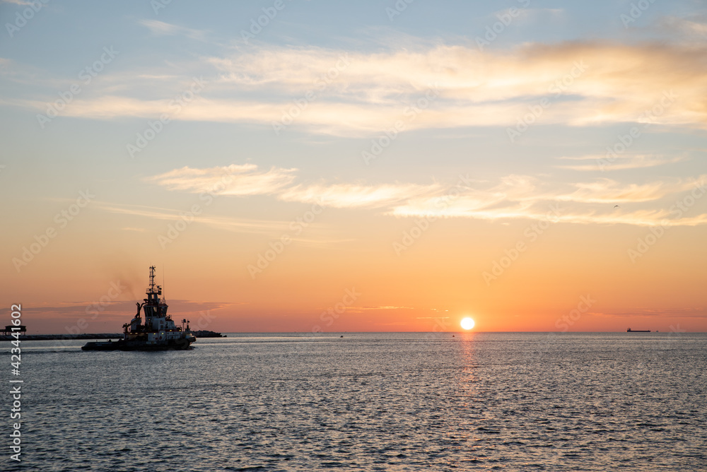 tugboat sailing on the sea at sunrise