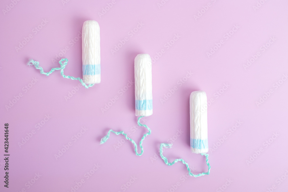 Sanitary tampon isolated on pink background. Beauty and hygiene concept. Sanitary tampon isolated on pink background. Beauty and hygiene concept.